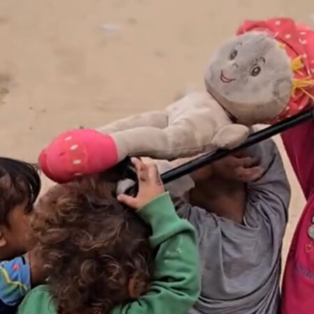 Children in Gaza reenact a funeral procession during play