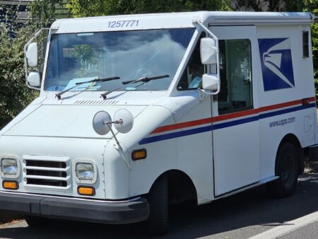 Troubled Postal Service moves to raise stamp prices, conserve cash