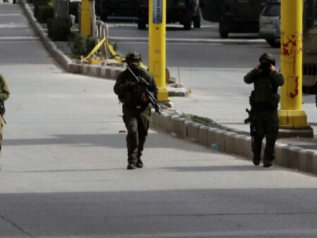 Israeli soldiers fire tear gas at Palestinian youth during raid in Hebron